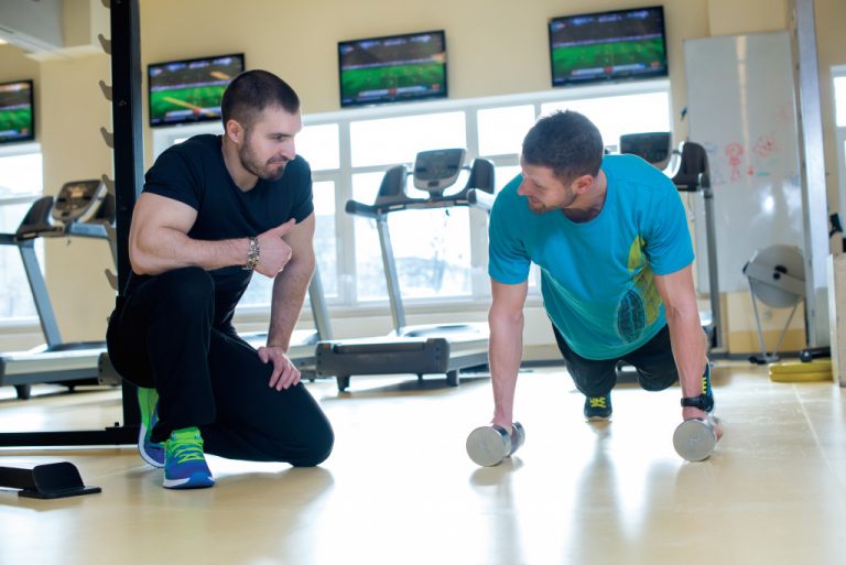 athlete trainer talking to male client